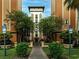 Exterior shot of a resort building, featuring lush greenery and a well-maintained walkway at 12527 Floridays Resort Dr # 401E, Orlando, FL 32821