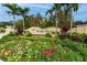 Exterior shot of the resort entrance with lush landscaping and a welcoming sign at 12527 Floridays Resort Dr # 401E, Orlando, FL 32821