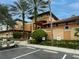 Exterior view of a well-maintained resort building with a golf cart parked in front of the entrance at 12527 Floridays Resort Dr # 401E, Orlando, FL 32821