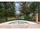 Tranquil hot tub area surrounded by lush greenery and a decorative fence at 12527 Floridays Resort Dr # 401E, Orlando, FL 32821