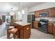 Well-equipped kitchen with stainless steel appliances, island, and breakfast bar seating at 12527 Floridays Resort Dr # 401E, Orlando, FL 32821