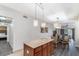 Well-equipped kitchen with a central island and open views of the dining and living areas at 12527 Floridays Resort Dr # 401E, Orlando, FL 32821