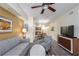 Comfortable living room with modern decor, a ceiling fan, and an open layout leading to the dining area at 12527 Floridays Resort Dr # 401E, Orlando, FL 32821