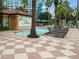 Relaxing hot tub with pool access and deck chairs at 12527 Floridays Resort Dr # 401E, Orlando, FL 32821