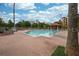 Large community pool with lounge chairs, a gazebo, and lush landscaping at 12527 Floridays Resort Dr # 401E, Orlando, FL 32821