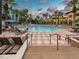 Inviting outdoor pool area with palm trees and comfortable lounge chairs for relaxation at 12527 Floridays Resort Dr # 401E, Orlando, FL 32821