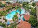 Aerial image showcases a large community pool surrounded by palm trees and lounge chairs at 12527 Floridays Resort Dr # 401E, Orlando, FL 32821