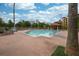 Outdoor pool surrounded by lounge chairs and a gazebo, set against a backdrop of trees and buildings at 12527 Floridays Resort Dr # 401E, Orlando, FL 32821