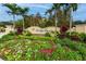 FloridaDays Resort sign with beautiful tropical flowers and palm trees, creating a welcoming entrance at 12527 Floridays Resort Dr # 401E, Orlando, FL 32821