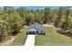 Aerial view of a single-Gathering home with a large yard surrounded by trees at 13274 Sw 82Nd Ln, Dunnellon, FL 34432
