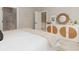 Bedroom boasts a woven cabinet, white bedding, and doorways to other rooms at 13274 Sw 82Nd Ln, Dunnellon, FL 34432