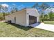 Spacious garage with black doors and exterior lights, perfect for parking and storage at 13274 Sw 82Nd Ln, Dunnellon, FL 34432