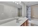 Well-lit bathroom featuring a large mirror and shower/tub combo at 1420 Prairie Oaks Dr, St Cloud, FL 34771