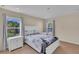 Bright bedroom with two windows, white furniture, and modern comforter at 1420 Prairie Oaks Dr, St Cloud, FL 34771