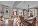 Open-concept living and dining area with hardwood floors, chandelier, and plenty of natural light at 1420 Prairie Oaks Dr, St Cloud, FL 34771