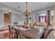 Spacious dining room featuring hardwood floors, a chandelier, and views into the living area at 1420 Prairie Oaks Dr, St Cloud, FL 34771