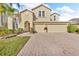 Charming two-story home featuring a well-maintained lawn and a welcoming three-car garage at 1420 Prairie Oaks Dr, St Cloud, FL 34771