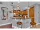 Kitchen area with bar top, pendant lights, stainless steel appliances, and hardwood cabinets at 1420 Prairie Oaks Dr, St Cloud, FL 34771