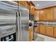 Spacious kitchen with stainless steel refrigerator and appliances, granite countertops and hardwood cabinets at 1420 Prairie Oaks Dr, St Cloud, FL 34771