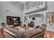 Bright living room with a large leather sectional, entertainment center, and an open view to the upstairs at 1420 Prairie Oaks Dr, St Cloud, FL 34771