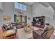 Inviting living room with soaring ceilings, comfortable leather seating, and a large entertainment center at 1420 Prairie Oaks Dr, St Cloud, FL 34771