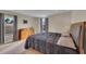 A well-lit bedroom with a bed, dresser, bedside lamps, and two windows at 1420 Prairie Oaks Dr, St Cloud, FL 34771