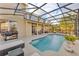 Inviting screened pool with a comfortable lounge area and outdoor grill at 1420 Prairie Oaks Dr, St Cloud, FL 34771