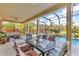 Outdoor screened-in patio with a pool, dining table, and comfortable seating at 1420 Prairie Oaks Dr, St Cloud, FL 34771