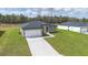 Aerial view of a modern home with a well-kept lawn and a paved driveway at 17052 Sw 44Th Cir, Ocala, FL 34473