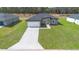 Overhead view of a modern home with a large driveway and green lawn at 17052 Sw 44Th Cir, Ocala, FL 34473