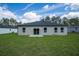 Well-maintained backyard with a view of the home's exterior and surrounding greenery at 17052 Sw 44Th Cir, Ocala, FL 34473