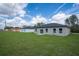 Expansive backyard with green lawn and views of the home's rear exterior at 17052 Sw 44Th Cir, Ocala, FL 34473