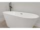 Modern soaking tub with matte black floor-mounted faucet at 17052 Sw 44Th Cir, Ocala, FL 34473