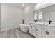 Bathroom featuring soaking tub, dual vanity and modern fixtures at 17052 Sw 44Th Cir, Ocala, FL 34473