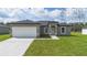 Charming single-story home with a well-maintained lawn and a two-car garage, offering a welcoming curb appeal at 17052 Sw 44Th Cir, Ocala, FL 34473