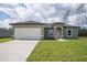 Charming single-story home with a well-manicured lawn and a two-car garage at 17052 Sw 44Th Cir, Ocala, FL 34473