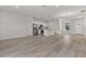 Open-concept living space with wood-look floors that connects the living room, dining area, and kitchen at 17052 Sw 44Th Cir, Ocala, FL 34473