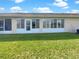 Backyard featuring a well maintained lawn and a glass enclosed porch at 1817 Christina Lee Ln, St Cloud, FL 34769
