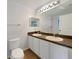 Bathroom featuring a double sink vanity, large mirror, and a toilet at 1817 Christina Lee Ln, St Cloud, FL 34769