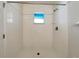 Bathroom featuring a tiled shower, window, and chrome hardware at 1817 Christina Lee Ln, St Cloud, FL 34769