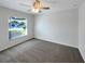 Cozy bedroom with neutral walls, plush carpet, and natural light from the window at 1817 Christina Lee Ln, St Cloud, FL 34769