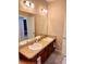 Bright bathroom featuring a double vanity, granite countertops, and ample cabinet storage at 1828 Lemon Drop Ct, Apopka, FL 32712