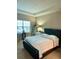 Inviting bedroom with a tray ceiling, large window, and comfortable bed at 1828 Lemon Drop Ct, Apopka, FL 32712