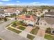 Aerial view of a two-story home with a well-manicured lawn, brick driveway and solar panels on the roof at 19313 Pummelo Dr, Orlando, FL 32827