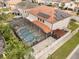 Aerial view of the home's backyard featuring a screened-in pool and spa, patio, and lush landscaping at 19313 Pummelo Dr, Orlando, FL 32827