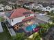 Aerial view of a house with a beautiful screened-in pool area, solar panels, and terracotta tile roof at 19313 Pummelo Dr, Orlando, FL 32827