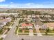 Aerial view of a residential neighborhood and the home's well-maintained landscaping, with a lake in the distance at 19313 Pummelo Dr, Orlando, FL 32827