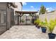 Stylish backyard featuring a paver patio, pergola, and potted plants at 19313 Pummelo Dr, Orlando, FL 32827
