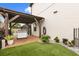 Cozy backyard featuring a covered patio, pet kennel, and lush artificial grass at 19313 Pummelo Dr, Orlando, FL 32827