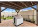 View of the brick-paved patio with a dog house under a wood-covered pergola at 19313 Pummelo Dr, Orlando, FL 32827